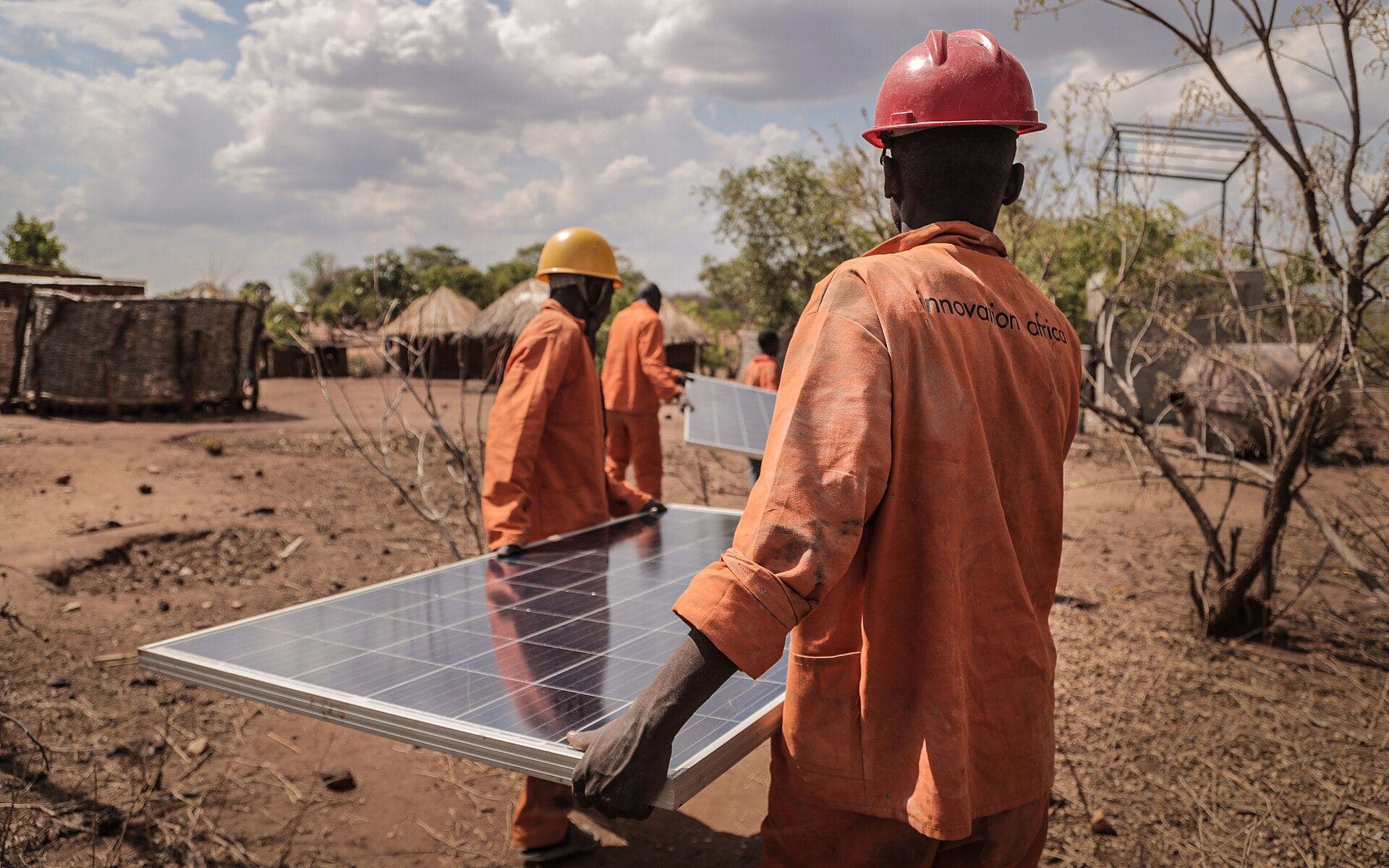 Technicians carrying a solar panel (Innovation: Africa)